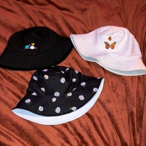 Saturn Bucket hat, butterfly bucket hat, and daisy/white reversible bucket hat,